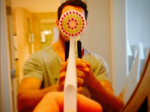 Ian Bohen showing tung brush in mirror